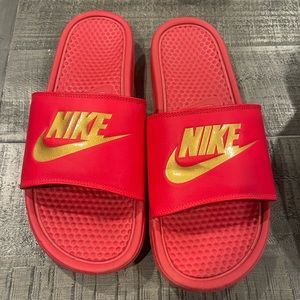 Red and gold Nike Slides